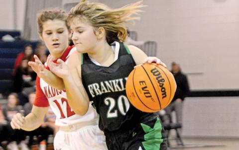 The Franklin County Middle School Lady Cub basketball teams finished their seasons Saturday in Elberton in the NEGIAA tournament. Seventh grade team member Chloe McFarlin drives past a Madison County defender. (Photo by Scoggins)