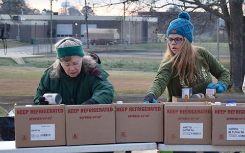Volunteers organize food for distribution in the back parking lot of Lavonia Church of God during the mobile food pantry. (Photo by Sinclair)