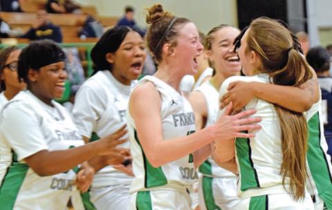Teammates swarm Lady Lion Kayleigh Chappell after the senior made a buzzer-beating layup to tie the game in regulation Tuesday against East Jackson. The Lady Lions defeated the No. 6 Lady Eagles 55-47 in overtime. (Photo by Scoggins)