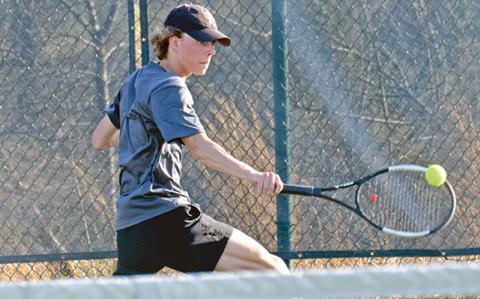 Franklin County singles tennis player Will Wester returns a ball during action last week at home against Oconee County. 