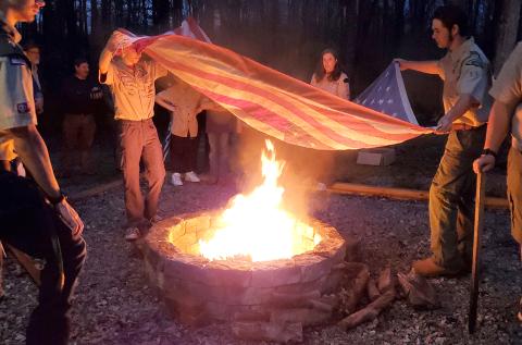 Lavonia Boy Scout Troop 51 members retire one of 15 worn American flags left in the flag retirement box during a flag retirement ceremony Monday at Lavonia Memorial Park. The ceremony was held following a fire pit dedication Monday night. Replacing the fire pit at the park was J.T. Strickland’s Eagle Scout project.