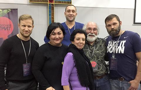 Dr. Harold Rhoades takes a moment to pose with Ukrainians, including his friend Yelena (front center), during one of his visits.