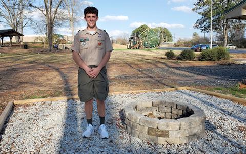 Lavonia Scout Troop 51 Eagle Scout J.T. Strickland stands beside the fire pit he built for his Eagle Scout Project. (Photo by Sinclair)