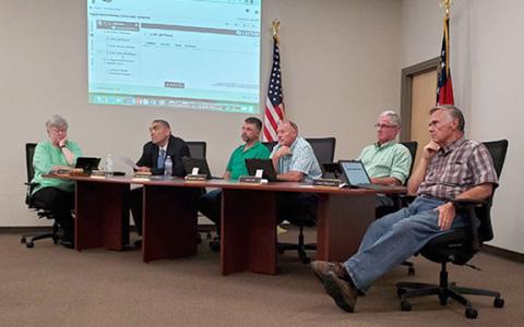 School board members and Superintendent Chris Forrer listen to Jeff Pierce speak during public comment at Tuesday's Franklin County Board of Education meeting. (Photo by Sinclair)