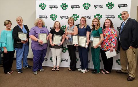 Assistant Superintendent Melanie Burton-Brown, Special Education Director Dr. Ashlee Underwood and Superintendent Chris Forrer congratulate school nurses Norina South, Carmen Jordan, Janice Holcombe, Donna Eavenson, Kayla Holland, and Anna Adams at the Franklin County Board of Education meeting Tuesday night. (Photo by Sinclair)