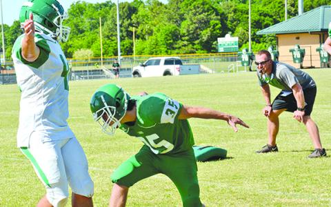 Franklin County Lion Head Coach Parker Martin (right) oversees a tackling drill during a spring practice session Tuesday at FCHS. (Photo by Scoggins)