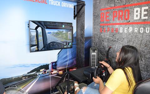 Keyry Moran tries out the truck driving simulator on the Be Pro Be Proud Mobile Workshop. (Photo by Sinclair)