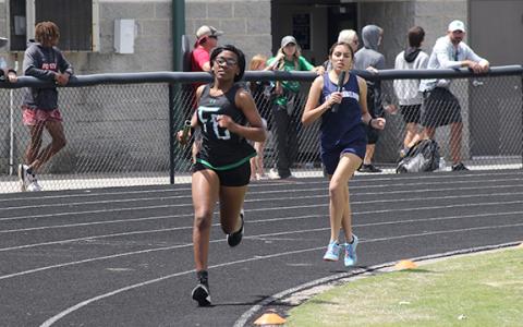 Delayshia Sturghill leads an East Jackson runner in the 4x800 relay at the state sectional meet Saturday in Commerce. (Photo courtesy of Marcus Etienne at The Toccoa Record)