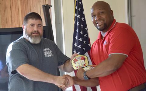 Royston Mayor Keith Turman presents the helmet badge to new Royston Fire Chief Matt Elrod. (Photos by Scoggins)