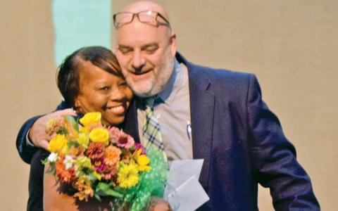 Yvonne Teasley gets a hug from Acting Franklin County School Superintendent Chuck Colquitt after being named the system’s Teacher of the Year Monday during convocation held at Franklin County High School. (Photo by Scoggins)