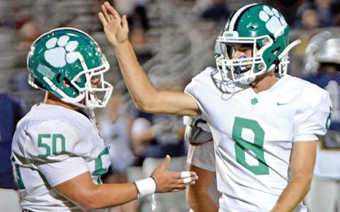 Tarryn Tate (left) and Jonathan Duncan celebrate Friday after Duncan’s 37-yard field goal against East Jackson.
