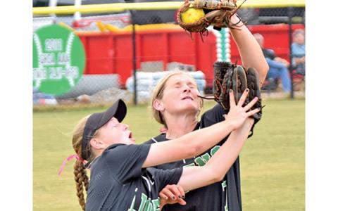 Lady Lion Journey Roberts makes a catch for an out over teammate (and sister) Lenox Roberts during the Region 8AAA tournament against Oconee County Oct. 12. (Photo by Scoggins)