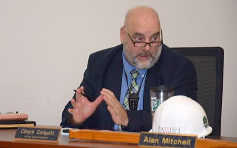 Acting Superintendent Chuck Colquitt wears a microphone around his neck to demonstrate a new audio system that has been installed in classrooms. Together with new cameras, the system allows teachers to video lessons for students unable to attend, and the microphones amplify voices so students can hear better. (Photo by Sinclair)