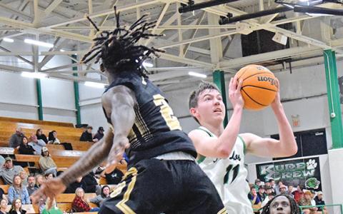 Bentley Huff avoids a block to put up a layup against Commerce Tuesday in the Lion’s Den. (Photos by Scoggins)