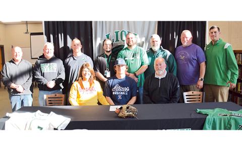 Franklin County High School senior shortstop Dee Oliver, surrounded by his parents, baseball and football coaches and high school administrators, signed Friday with Emmanuel College. (Photo by Scoggins)