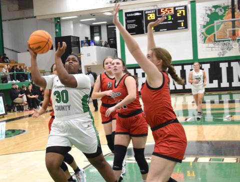 Myah Strange puts up a shot against Jackson County in action Friday in the Lion’s Den. She scored nine points in the game despite missing time due to injuries. (Photos by Scoggins)