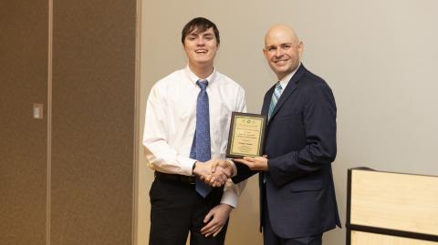 Franklin County Chamber of Commerce President Raymond Fitzpatrick (right) presents Christopher Forrer with a plaque honoring late Franklin County School Superintendent Chris Forrer as the chamber’s Charles Bradshaw Citizen of the Year. The award was presented at the chamber’s Membership Gala Thursday at the North Georgia Tech Currahee Campus.