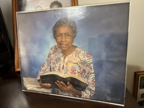 A photo in Geneva Butler’s home shows her with her Bible. Butler said her life motto is “Do what all I can for the Lord, while I can.” Reading her Bible is a favorite pasttime, she said. (Photo by Raese)