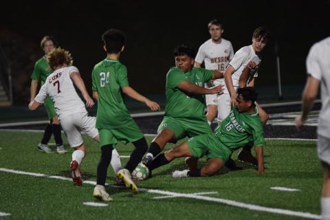 Franklin County Lion defenders Jorge Mendez (No. 24), Bryan Valle (No. 25) and Rodrigo Valle (No. 16) surround a ball near the goal in a game last week against Hebron Christian. (Photo by Scoggins)