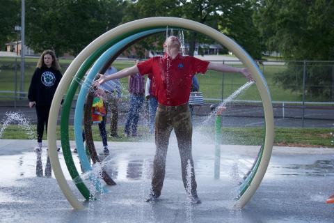 Lavonia City Council member Andrew Murphy takes in the full experience of the city’s new splash pad during a demonstration following the council’s meeting Monday night.