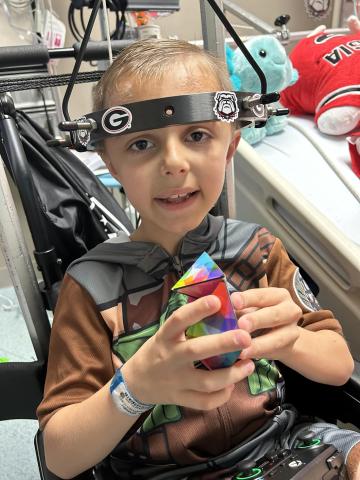 Alex Adams, a young scoliosis patient, underwent a procedure at Childrens Hospital of Atlanta using a halo device to help his condition.