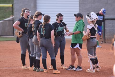 Head Coach Cherokee Bell (right photo) meets with her infield during Tuesday’s contest. (Photos by Scoggins)
