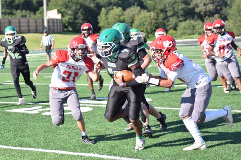 Eighth grader Kendaus Burtch runs through would-be Stephens County tacklers in the Franklin County Middle School Cubs’ season opening win Thursday at Jeff Davis Field at Ed Bryant Stadium. (Photo by Scoggins)