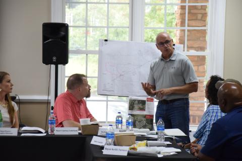 County Engineer John Phillips presents options last week to the IBA to expand sewer service in the area of Exit 160 on I-85. (Photo by Scoggins)