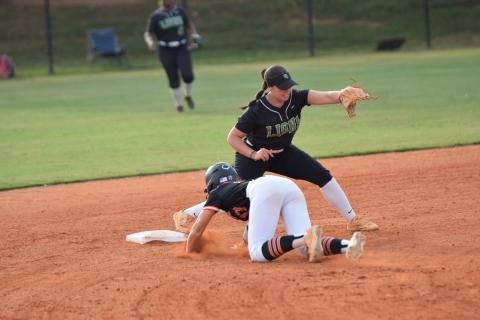 Senior Karson Johnson (left photo) smiles while standing on second after a double Tuesday against Hart County. Junior McCall Davis (right photo) delivers a pitch. (Photos by Scoggins)