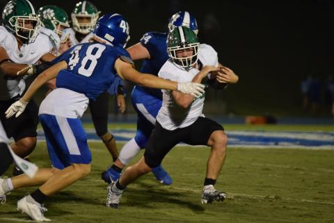Senior Brady Simms runs past a Banks County defender during Friday night’s game in Homer. Simms finished with 221 yards rushing for the Lions. (Photo by Scoggins)