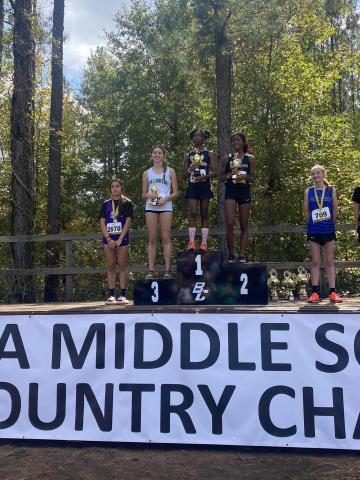 FCMS Lady Cub Savannah Jackson (second from left) took third in the State Middle School Cross Country Meet Saturday in Cochran.