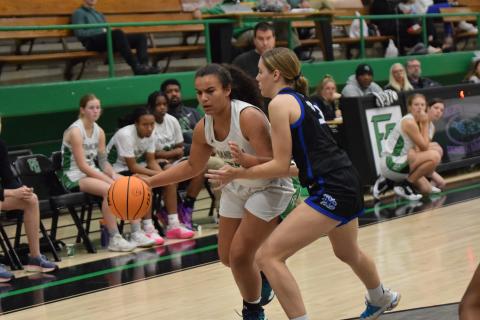 Kallie Thrift dribbles past an Oconee County defender during action Tuesday in the Lion’s Den.
