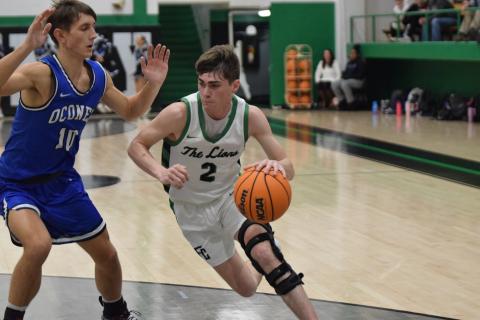 Carson Coulter drives past an Oconee defender Tuesday on his way to two of his 10 points in a Franklin County victory. 