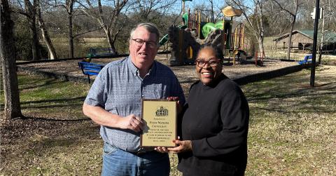 Now former Mayor Harris Little presents Patsy Watkins with a plaque to commemorate her eight years of service on the Carnesville City Council. 