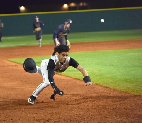 Kain Roach dives into third base after serving as a courtesy runner against Apalachee. (Photo by Scoggins)