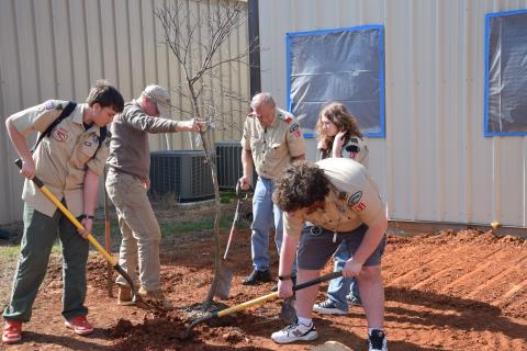Lavonia Boy Scout Troop 51 members Noah Roberson, Nathan Estrada, Kelsey Bennett and leader Greg Weaver help arborist John Sherouse plant a red Japanese maple at the Northeast Georgia Animal Shelter. The tree was planted in honor of the late Margaret Ayers. (Photos by Scoggins)