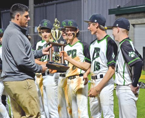 Franklin County Athletic Director Clay Moore presents the NEGIAA region baseball championship trophy to the Franklin County Middle School Cubs after FCMS swept Stephens County Monday for the region title. (Photo by Scoggins)