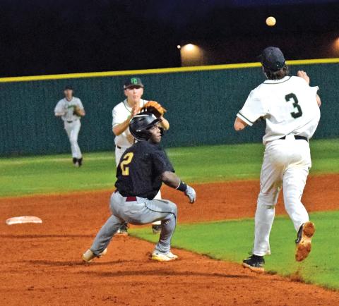 Easton Gailey and Luke Beasley (above) catch a Hebron runner in a rundown during Region 8AAA action Monday at FCHS.
