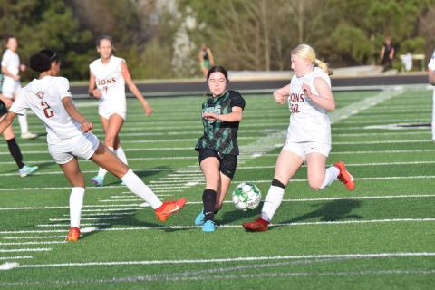 Lady Lion Brooke Davitt splits defenders during action against Hebron Christian Thursday at Jeff Davis Field at Ed Bryant Stadium. (Photos by Scoggins)