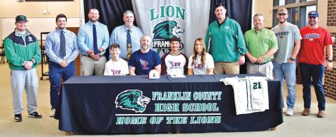 Lion senior Keilin Sanders (seated center) is pictured with his family – father Lyles Sanders, mother Crystal Sanders and brother Talon Sanders – and coaches from Franklin County High School, Franklin County Middle School and travel ball team Line Drive Academy during his signing ceremony Monday at FCHS. (Photo by Scoggins)