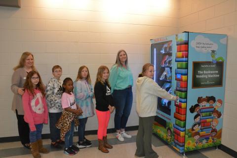 Students at Carnesville Elementary stand in line to try the new “Inchy” the Bookworm’s Book Vending Machine. The machines were recently placed in Carnesville, Royston and Lavonia Elementary Schools. The schools use the program as an incentive for the children to read more. Depending on the school, the rewards are based on behavior, attendance and/or grades. The eager readers are (from left) Freya Kolton, Will Cain, Jade Johnson, Keri Taylor and McKenna Carter. Looking on are (from left) Rita Shoemaker, dire