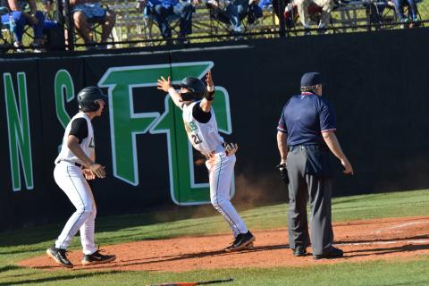 Easton Gailey and Keilin Sanders celebrate after Sanders scored a run in recent region action at FCHS.