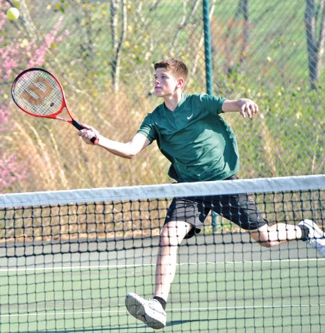 Martin Lunsford (above) returns a ball in tennis action earlier this season. 