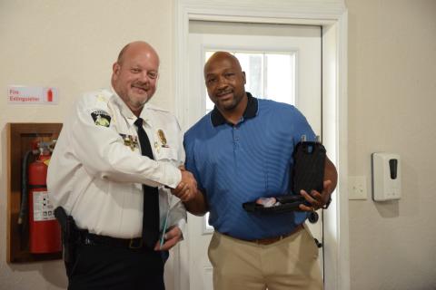 Royston Mayor Keith Turman (right) presents retiring Police Chief Donnie Bolemon (left) with a gift and his service weapon Tuesday during a reception. (Photo by Scoggins)