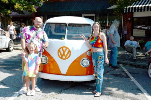 Flashing the peace sign in front of a very rare Volkswagen pickup truck are Scott Seward, Lily Seward and Bridget Cobb.