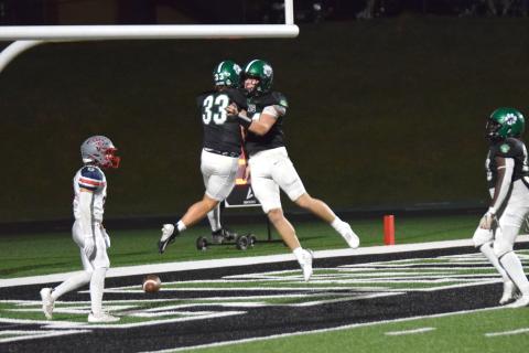 Keyes Harbin and Ramsey Fulbright (above) celebrate a touchdown Friday night during the Lions’ Homecoming game against West-Oak.