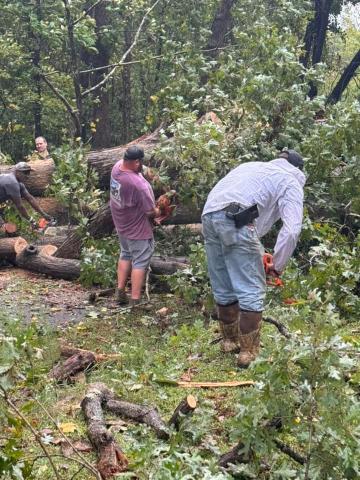 Jeremy “Bud” Fulghum and Michael Certain of Line Fire Department, with help from a Franklin County Detention Center work crew, clear a tree that fell over Burgess Road in Franklin County after the remnants of Hurricane Helene blew through the county Thursday night and Friday morning. (Photo courtesy of Ginger Fulghum)