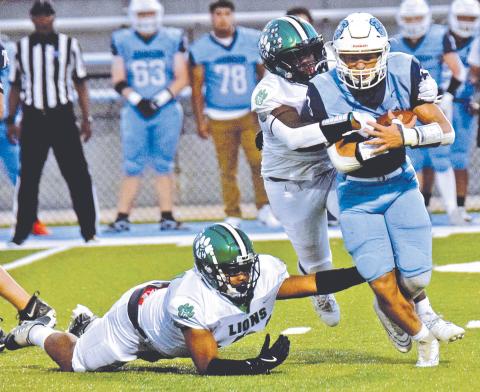 The Franklin County Lion defense, pictured in action against Johnson of Gainesville earlier this season, will look to hold down a powerful Prince Avenue Wolverines team Friday night in Bogart.