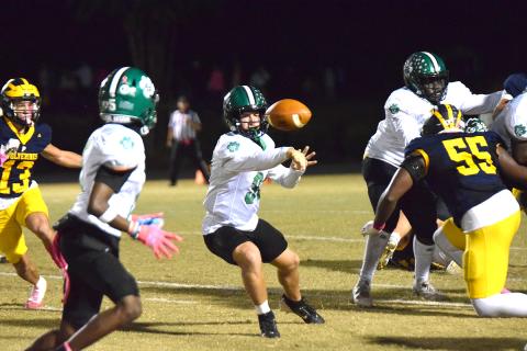Quarterback Keyes Harbin makes an option pitch to Gavin Wells in action Friday against Prince Avenue Christian in Bogart. (Photo by Scoggins)