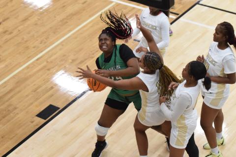 Takiyah Merriett battles for a rebound in action Thursday at Commerce. (Photos by Scoggins)
